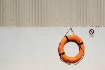 A lifebuoy ring hung on a white wall.